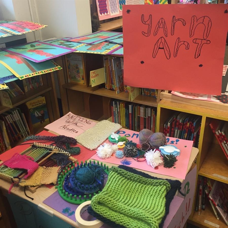 yarn art - yarn and items along with knitting tools like a loom